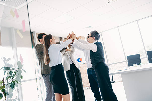 istock Professional coworkers celebrating teamwork success with a high-five gesture in a modern office environment 2237271139