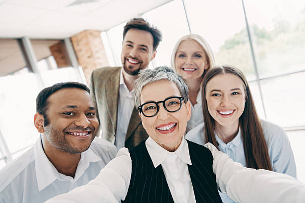 istock Diverse group of professionals smiling in an office setting, collaborating and fostering teamwork in a formal workspace 2237271200