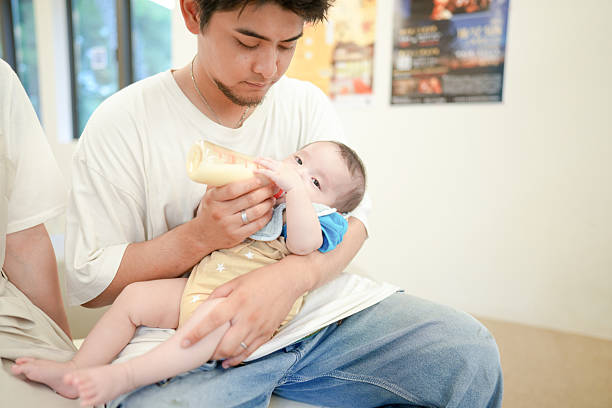 istock A man is feeding a baby with a bottle 2237271326