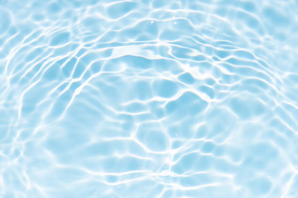 istock Blue water with ripples on the surface. Defocus blurred transparent blue colored clear calm water surface texture with splashes and bubbles. Water waves with shining pattern texture background. 2237272257