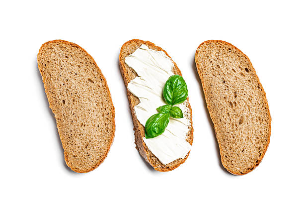 Bread with butter and slices of bread isolated on white background, top view, design elements.