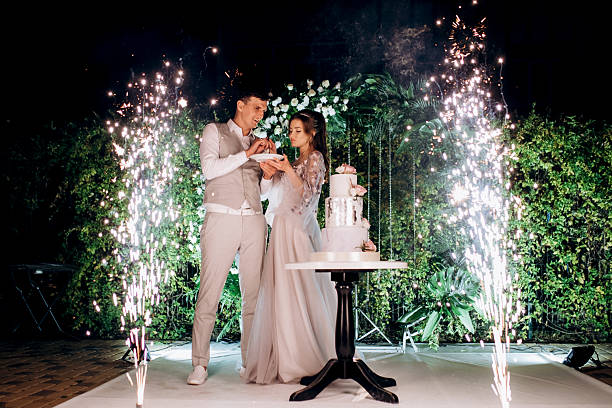 istock newlyweds happily cut and taste the wedding cake 2237273772