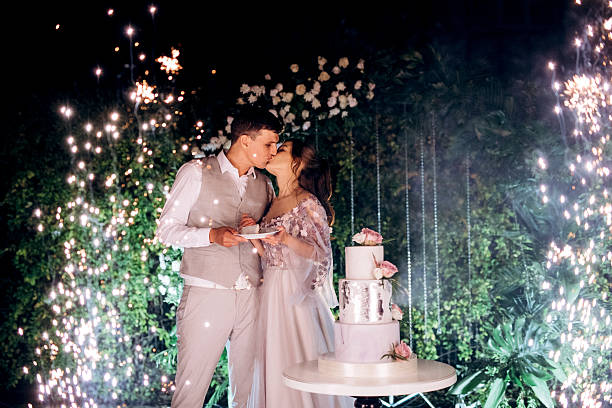istock newlyweds happily cut and taste the wedding cake 2237273980