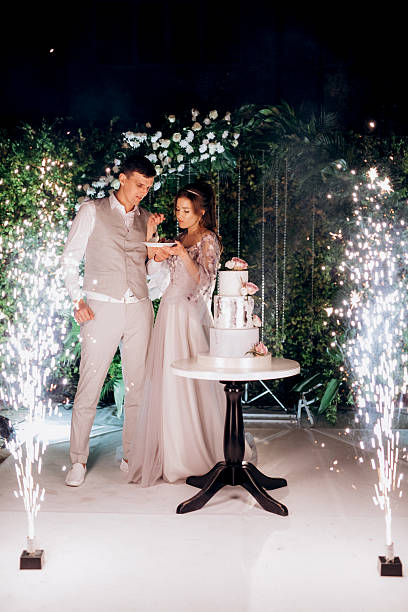 istock newlyweds happily cut and taste the wedding cake 2237274300