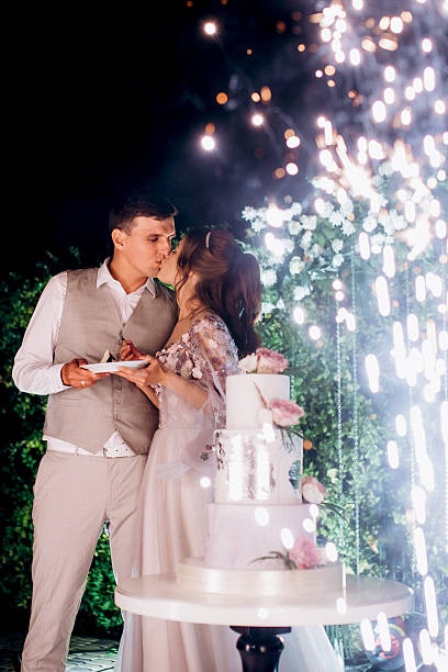 istock newlyweds happily cut and taste the wedding cake 2237275048