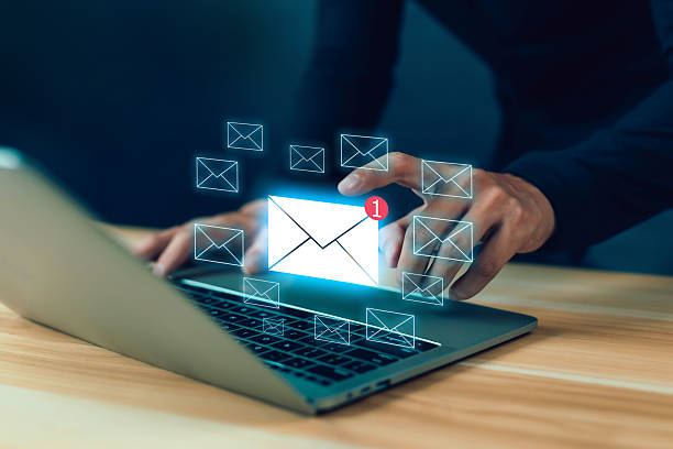 istock Businessman using laptop with digital email icons and notification alert symbolizing online communication, email marketing, messaging service, and modern digital business connection. 2237275727