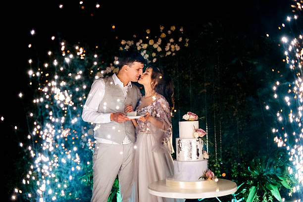 istock newlyweds happily cut and taste the wedding cake 2237276205