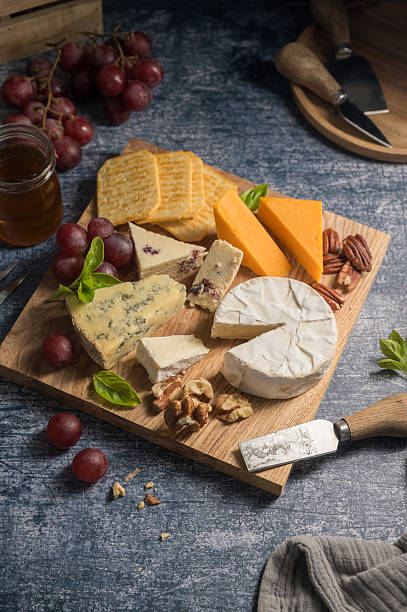 istock Cheese board, different types of cheese on a board, served with grapes 2237277083