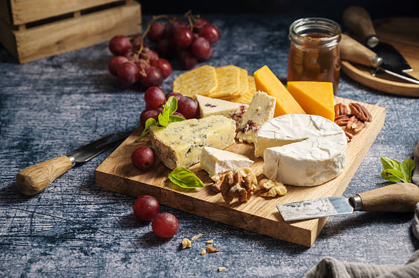 istock Cheese board, different types of cheese on a board, served with grapes 2237277142