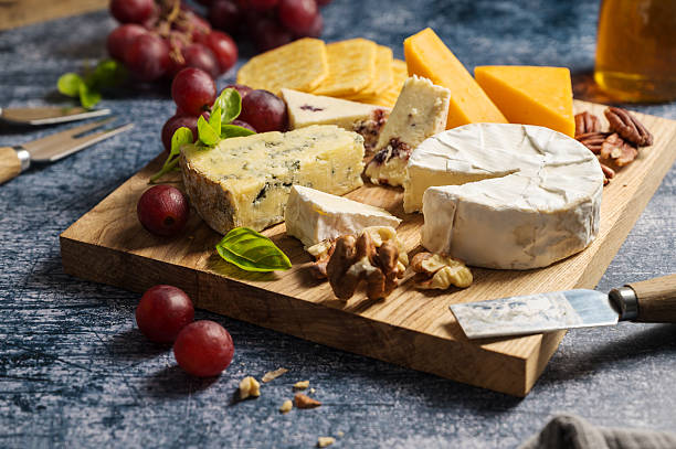 istock Cheese board, different types of cheese on a board, served with grapes 2237277145