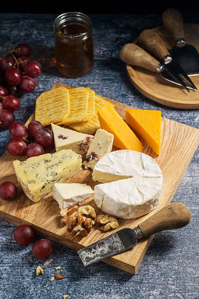 istock Cheese board, different types of cheese on a board, served with grapes 2237277340