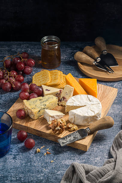 istock Cheese board, different types of cheese on a board, served with grapes 2237277395
