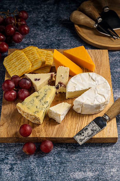 istock Cheese board, different types of cheese on a board, served with grapes 2237277404