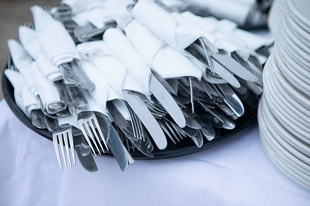 istock Stack of knives and forks wrapped in napkins on a buffet table 2237278770