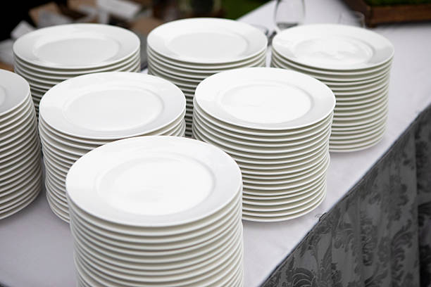 A long banquet table is beautifully arranged with various dishes, colorful salads, and drinks. Soft lighting and elegant decor create a festive atmosphere for the gathering.