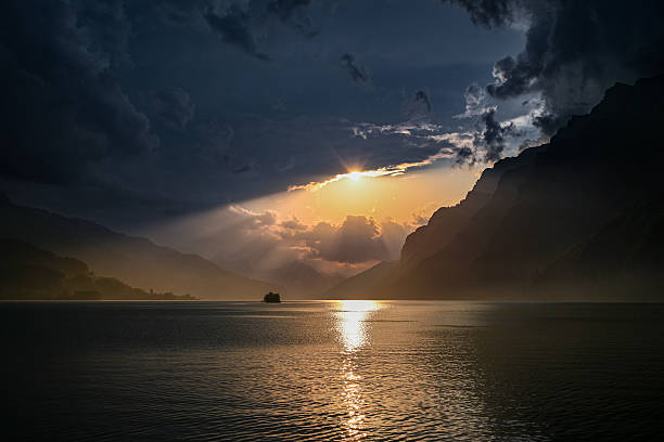 Sunset over mountains, sailboat and lake, Lago Maggiore