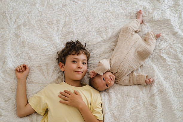 istock Two brothers enjoying playing in cozy bright bedroom 2237280648