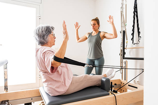istock Senior Woman Engages in Pilates Session With Instructor in Bright Studio Setting 2237281566