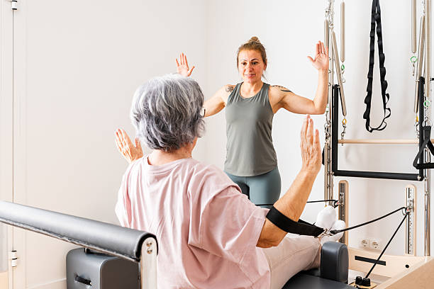 istock Senior Woman Participating in Pilates Session Led by Instructor in Bright Studio Setting 2237281584