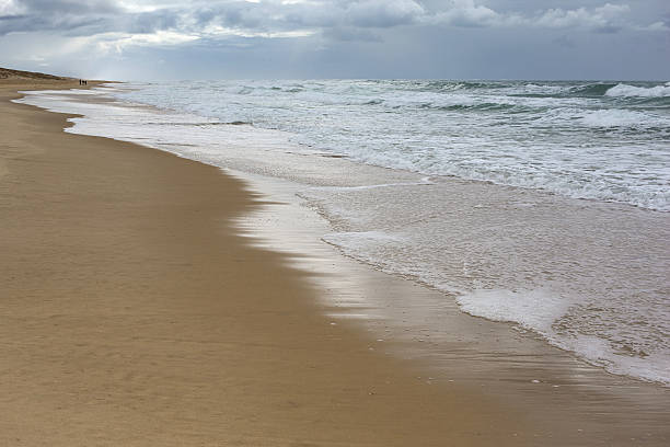 istock Walking on the beach in stormy weather 2237284458