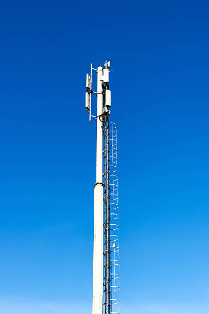 istock Tall metal communication tower with antennas stands under clear blue sky. Supports mobile and wireless networks, signal booster. Industrial vertical background, technology and connectivity outdoors. 2237285675