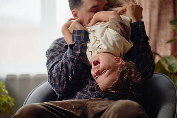 istock Caucasian Father Holding Laughing Child Upside down 2237285981