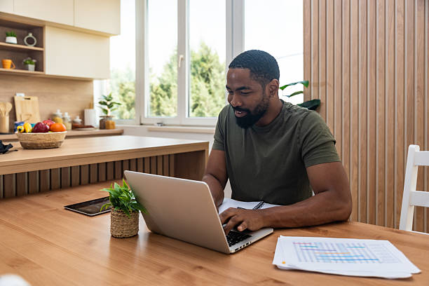 istock Young university student, freelancer business man, working at home on laptop computer, testing new innovative technology and online internet tools while sitting in home office. 2237286911