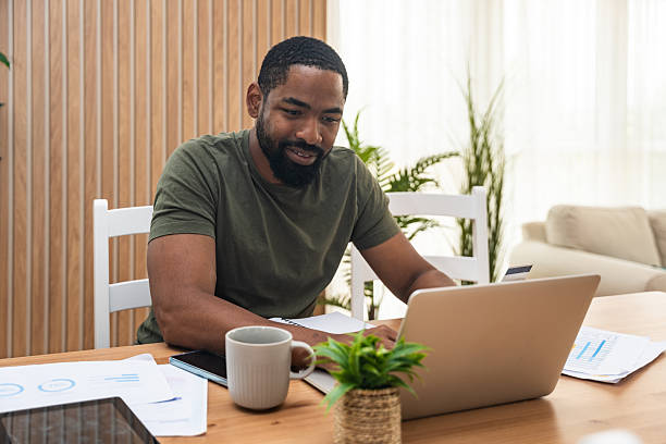 istock Young university student, freelancer business man, working at home on laptop computer, testing new innovative technology and online internet tools while sitting in home office. 2237286929