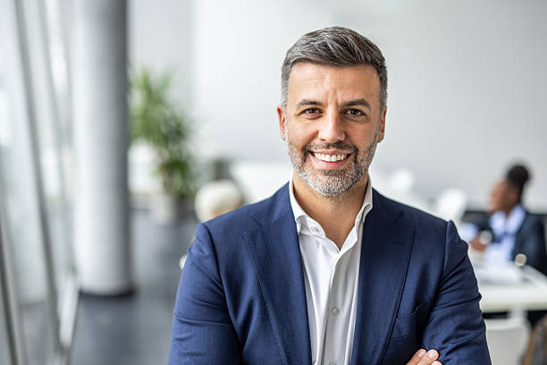 istock Businessman smiling, standing in modern office, portraying confidence 2237290536