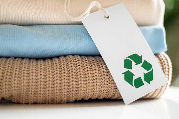 istock Eco-friendly clothing with recycle label on soft textile stack for sustainable fashion concept 2237292034