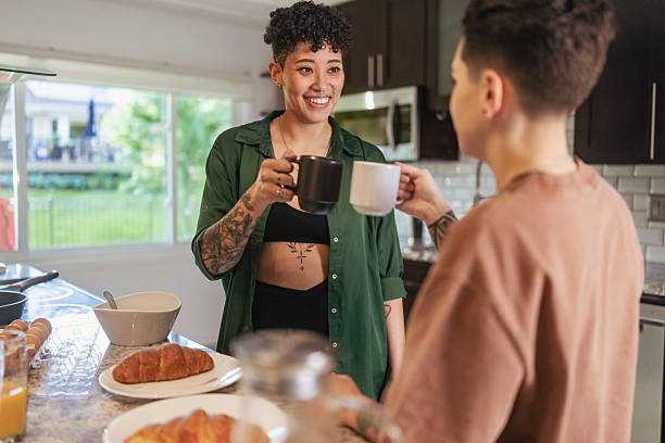 istock Lesbian Couple Sharing Morning Coffee in Bright Kitchen 2237293143