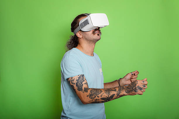 Man wearing VR headset against green background