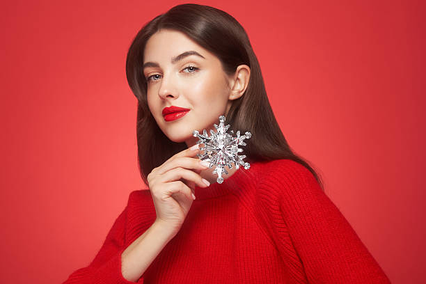 istock Beautiful young woman with glowing snowflake 2237297406