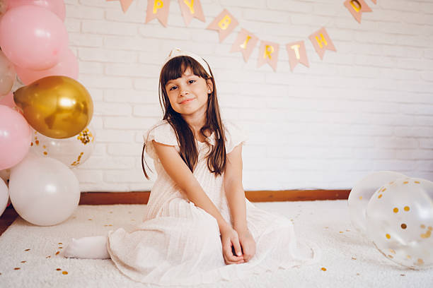 Cute girl celebrating a birthday. She looking at camera.