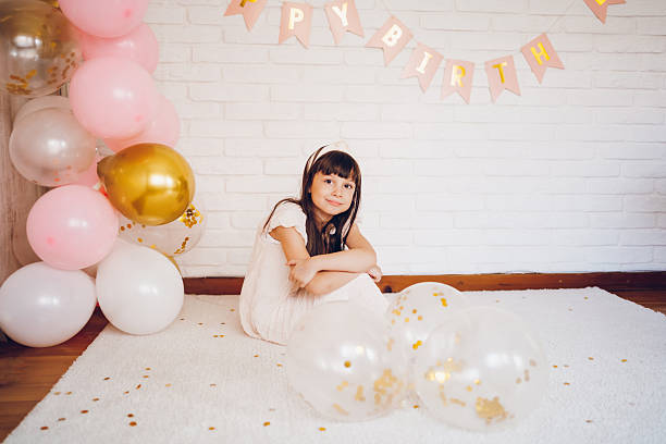 Cute girl celebrating a birthday. She looking at camera.