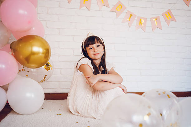 Cute girl celebrating a birthday. She looking at camera.
