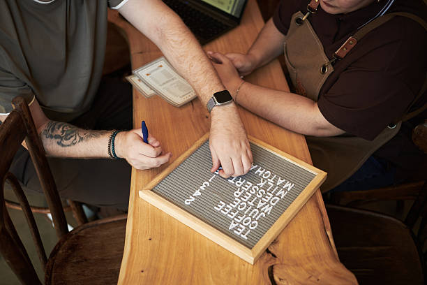 istock Young Caucasian Man and Middle Aged Man Arranging Letters on Board Together 2237303363