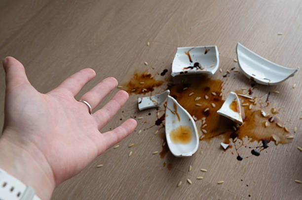 istock An unintentional spill occurred due to a broken plate, resulting in a surprised hand reaction 2237304452