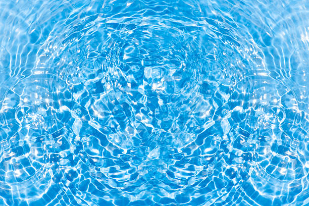 Round droplets of water over circles on pool water. 11