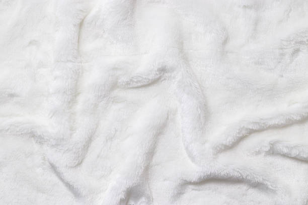 istock White Faux Fur Texture, Soft, white artificial fur with fluffy texture and gentle shadows. Close-up textile background delicate textures, top view, copyspace, backdrop with soft folds 2237305709