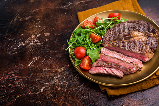istock Dinner with Grilled Rib eye steak, fried dry aged beef meat. brown background. top view 2237306609