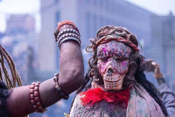 Varanasi, Uttar Pradesh, India - March 2024: Masan Holi, Portrait of unidentified devotee with mask during the celebration of masan holi at manikarnika ghat.