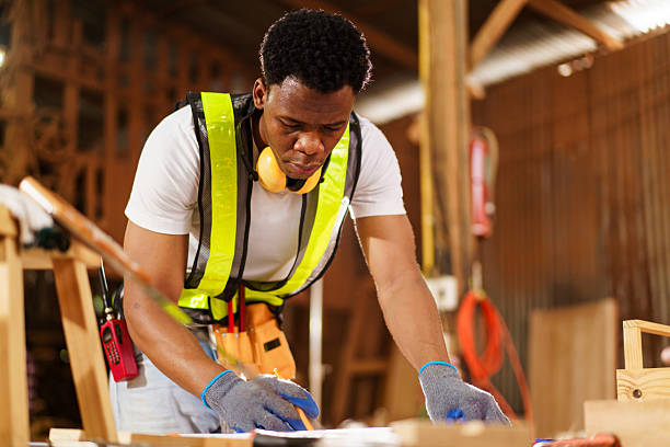 istock Carpenter sketching furniture plans in workshop, and drawing designs. 2237308408