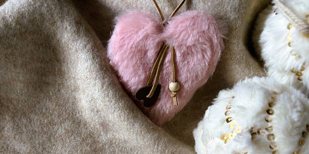 istock Fluffy pink heart Christmas ornament on beige textile. 2237309105