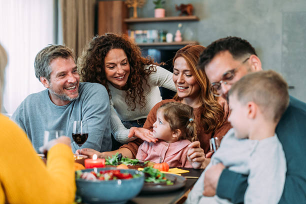 istock Happy extended family celebrating Thanksgiving at dining table. 2237309733