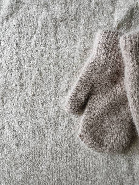 istock Vertical Muted Background with Soft Winter Glove Detail on the Right Side. 2237310014