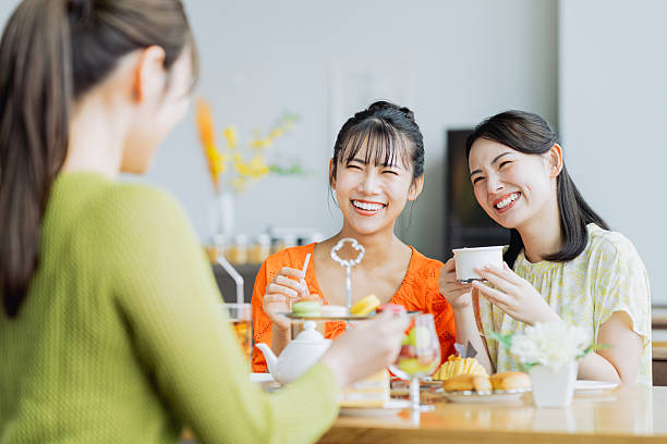istock Young woman enjoying afternoon tea at a cafe 2237310625