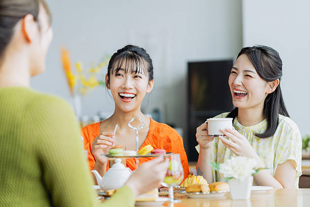 istock Young woman enjoying afternoon tea at a cafe 2237310626