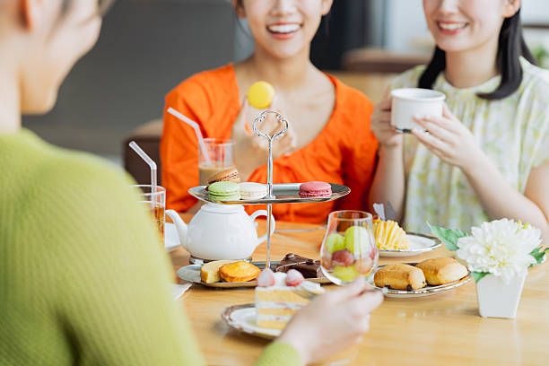 istock Young woman enjoying afternoon tea at a cafe 2237310635