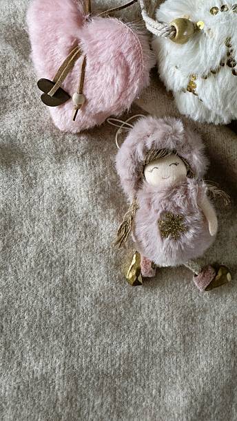 istock Vertical Close-up: Handmade Pink Fur Doll and White Christmas Ornaments. 2237311092